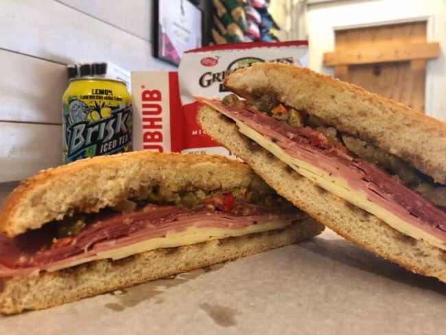 The best Muffuletta sandwich outside of New Orleans with Provolone, Capicola, Mortadella, Salami, and an Olive Salad on Muffuletta bread at Rosie’s Sidekick Sandwich Shop. The Best Muffuletta in Chicago.